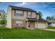Traditional two-story home featuring brick accents, shutters and an attached two-car garage at 5351 Eel River Ct, Indianapolis, IN 46221