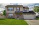Charming two-story home with a well-manicured lawn and attached two-car garage at 5351 Eel River Ct, Indianapolis, IN 46221