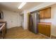An open kitchen features stainless appliances, wood cabinets and pink countertops, with the laundry room visible at 5351 Eel River Ct, Indianapolis, IN 46221