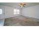 Empty living room with neutral carpet, ceiling fan and lots of natural light at 5351 Eel River Ct, Indianapolis, IN 46221