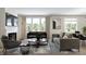 Comfortable living room with a fireplace, a view of the backyard and modern furniture on top of an area rug at 5774 Cloister Ln, McCordsville, IN 46055