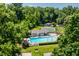 Aerial view showcasing community pool, tennis court, and mature trees at 5800 Lawrence Dr, Indianapolis, IN 46226