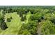Expansive golf course with mature trees and a winding stream creating picturesque scenery at 5800 Lawrence Dr, Indianapolis, IN 46226