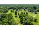 Aerial view of a lush golf course surrounded by mature trees and serene landscaping at 5800 Lawrence Dr, Indianapolis, IN 46226