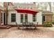 Beautiful brick patio features outdoor seating and umbrella, perfect for entertaining at 5800 Lawrence Dr, Indianapolis, IN 46226