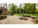 Backyard patio featuring a fire pit, a hot tub, and a beautifully landscaped garden at 5800 Lawrence Dr, Indianapolis, IN 46226