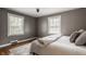 This bedroom features hardwood floors, natural light from two windows, and fresh paint at 5800 Lawrence Dr, Indianapolis, IN 46226
