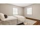 This bedroom has hardwood floors, a light and airy feel, and a decorative rug at 5800 Lawrence Dr, Indianapolis, IN 46226