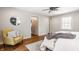 This bedroom has hardwood floors, natural light, a ceiling fan and a sitting area with stylish chair at 5800 Lawrence Dr, Indianapolis, IN 46226