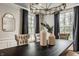 Bright dining room with wainscoting, chandelier, and dark wood table centerpiece at 5800 Lawrence Dr, Indianapolis, IN 46226