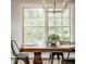 The dining room features a table with seating beneath a stylish chandelier at 5800 Lawrence Dr, Indianapolis, IN 46226