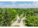 Grand gated entrance featuring tree-lined driveways with lush greenery, creating a welcoming atmosphere at 5800 Lawrence Dr, Indianapolis, IN 46226