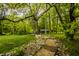 Idyllic cabin in the woods with stone pathway, offering a serene escape and natural beauty at 5800 Lawrence Dr, Indianapolis, IN 46226