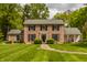 Charming two-story brick home with a symmetrical design and lush, manicured front lawn at 5800 Lawrence Dr, Indianapolis, IN 46226
