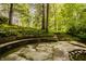 Outdoor seating area featuring curved stone benches and a serene water feature, blending seamlessly with nature at 5800 Lawrence Dr, Indianapolis, IN 46226