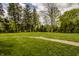 Lush green lawn with mature trees and landscaping, offering a serene outdoor space at 5800 Lawrence Dr, Indianapolis, IN 46226