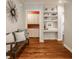 Entryway featuring hardwood floors, built-in shelving, and decorative mirror at 5800 Lawrence Dr, Indianapolis, IN 46226