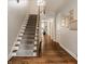 Hallway with wood floors and stairway with carpet runner at 5800 Lawrence Dr, Indianapolis, IN 46226