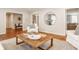 Bright living room featuring hardwood floors, and a round mirror on the wall at 5800 Lawrence Dr, Indianapolis, IN 46226