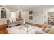 Inviting living room features custom built-ins, neutral paint, hardwood floors and a bright, airy feel at 5800 Lawrence Dr, Indianapolis, IN 46226