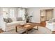Bright living room featuring hardwood floors, a white sofa, and doors leading to the outside at 5800 Lawrence Dr, Indianapolis, IN 46226