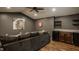 Stylish living room with gray walls, modern decor, a comfortable couch, and a convenient wet bar at 5800 Lawrence Dr, Indianapolis, IN 46226