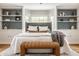 Serene bedroom features built-in cabinets, bay window, neutral colors, and a cozy bench at 5800 Lawrence Dr, Indianapolis, IN 46226
