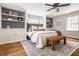 Spacious bedroom with hardwood floors, custom shelving, and a bench at 5800 Lawrence Dr, Indianapolis, IN 46226