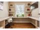 This office features hardwood floors, custom built-in shelves, and a desk with a window view at 5800 Lawrence Dr, Indianapolis, IN 46226