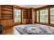 Bright office featuring wood paneling, hardwood floors, large windows, and built-in shelving at 5800 Lawrence Dr, Indianapolis, IN 46226
