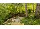 Picturesque stone water feature nestled among trees and foliage, inviting relaxation and serenity at 5800 Lawrence Dr, Indianapolis, IN 46226