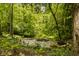 Scenic outdoor water feature with stone accents and lush vegetation, creating a peaceful ambiance at 5800 Lawrence Dr, Indianapolis, IN 46226