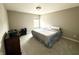 Simple bedroom featuring a large bed, neutral walls, carpeted floors, and a window for natural light and ventilation at 6309 Harvey Dr, Plainfield, IN 46168