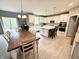 Open-concept kitchen and dining area with an island, white cabinetry, and stainless steel appliances at 6309 Harvey Dr, Plainfield, IN 46168