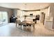 Well-appointed kitchen with island, barstool seating, modern appliances and view to dining area at 6309 Harvey Dr, Plainfield, IN 46168