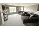 Open concept living room featuring plush carpeting, comfortable seating, and natural light from the large window at 6309 Harvey Dr, Plainfield, IN 46168