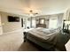 Bright main bedroom features a ceiling fan, carpet, and windows dressed with curtains for enhanced privacy at 6309 Harvey Dr, Plainfield, IN 46168