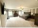 Spacious main bedroom with carpet, ceiling fan, large windows, and neutral paint, creating a peaceful retreat at 6309 Harvey Dr, Plainfield, IN 46168