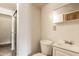 Simple bathroom features a shower, toilet, and sink with overhead storage at 647 Coffey St, Indianapolis, IN 46221