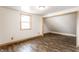 Bedroom with wood-look flooring and a window for natural light at 647 Coffey St, Indianapolis, IN 46221