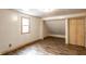 Cozy bedroom with hardwood floors, a built-in closet and a window at 647 Coffey St, Indianapolis, IN 46221
