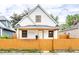 Charming two-story home with a bright yellow fence and inviting front porch at 647 Coffey St, Indianapolis, IN 46221