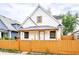 Charming two-story home with a bright yellow fence and inviting front porch at 647 Coffey St, Indianapolis, IN 46221