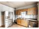 Kitchen featuring wooden cabinets, laminate counters and a stainless-steel refrigerator at 647 Coffey St, Indianapolis, IN 46221