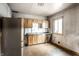 Kitchen featuring wooden cabinets, laminate counters and a stainless-steel refrigerator at 647 Coffey St, Indianapolis, IN 46221