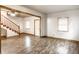 Bright living room with laminate flooring, staircase and natural light at 647 Coffey St, Indianapolis, IN 46221
