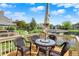 Deck features a table and chairs with a view of the backyard and pond at 6505 Miramar Ct, Indianapolis, IN 46250