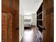 View through wooden doors into a bedroom with hardwood floors and a bed with built-in cabinets at 6505 Miramar Ct, Indianapolis, IN 46250