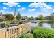 Outdoor deck with a table set, offering a relaxing view over the tranquil water and greenery at 6505 Miramar Ct, Indianapolis, IN 46250