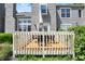Exterior shot highlighting a wooden deck with outdoor furniture and lush, mature landscaping at 6505 Miramar Ct, Indianapolis, IN 46250